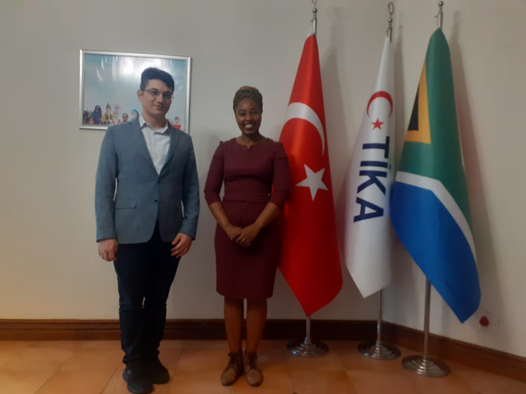 iButho Le Africa representative standing with international partner flags