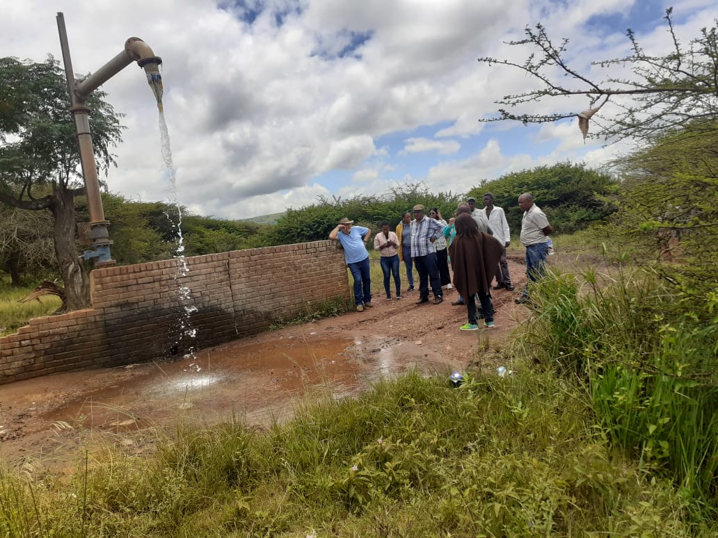 Community members gathered near a rural water point